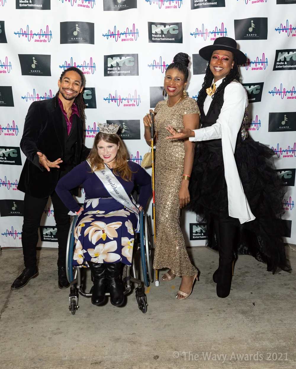 Four smiling guests at The Wavy Awards step-and-repeat